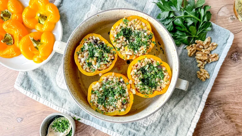 Four Barley And Walnut-Stuffed Bell Peppers in a casserole pan