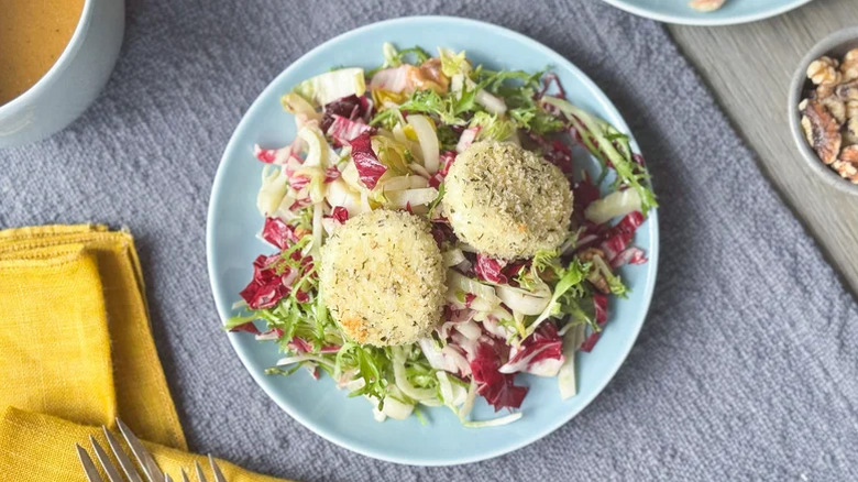 Light blue plate of Breaded And Baked Goat Cheese Salad