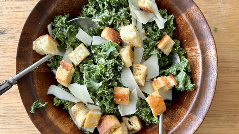 Wooden salad bowl filled with Easy Kale Caesar Salad