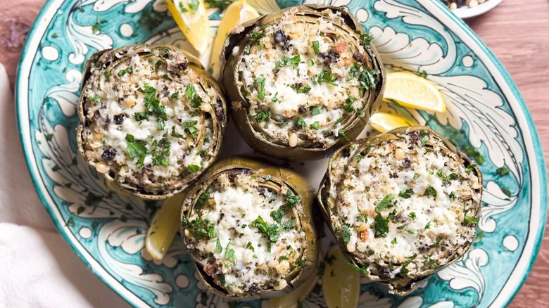 Decorative blue plate with four Sicilian-Style Stuffed Artichokes