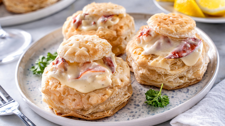 Three puff pastries  filled with lobster Newburg on a plate