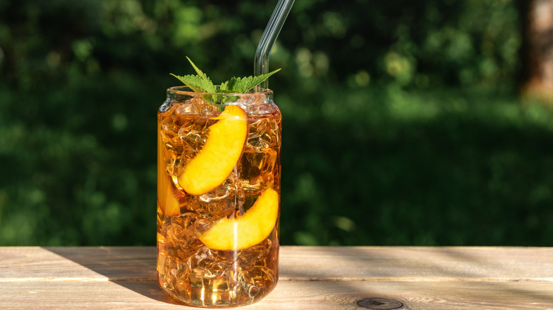 Glass of peach iced tea with ice