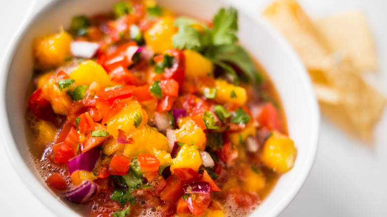 Bowl of peach salsa with chips