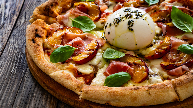 Peach with burrata ball on table