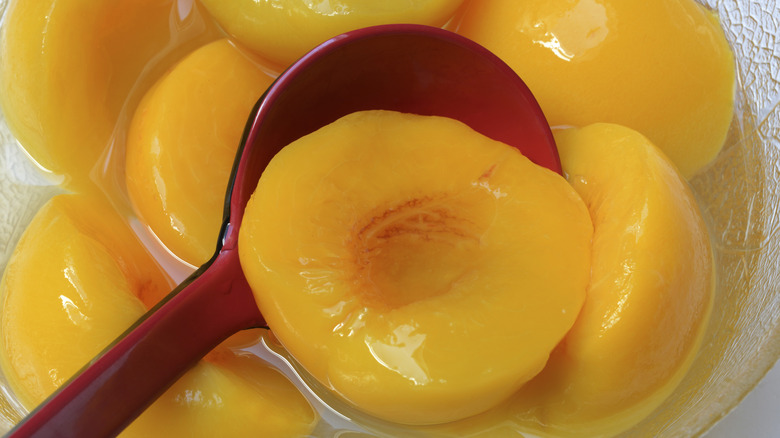 Pickled peaches with a spoon