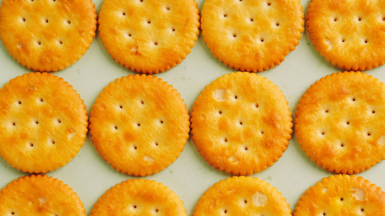 Ritz crackers on a green background
