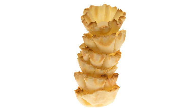 phyllo shells stacked against a white background