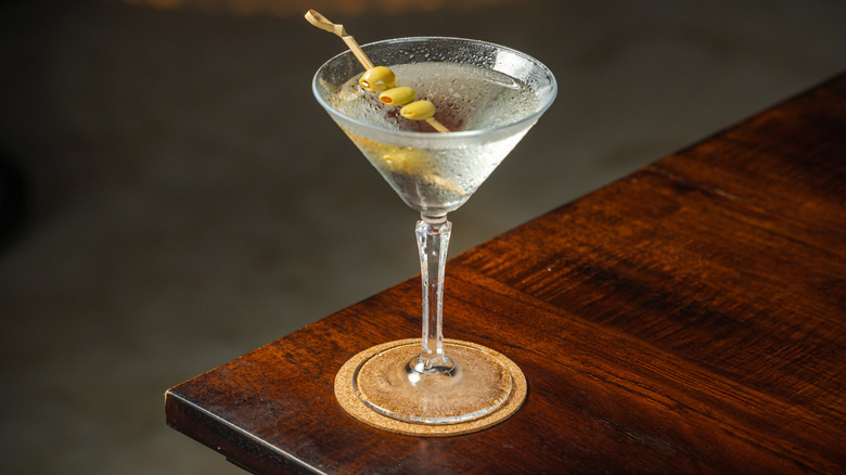 Dirty martini on wooden table