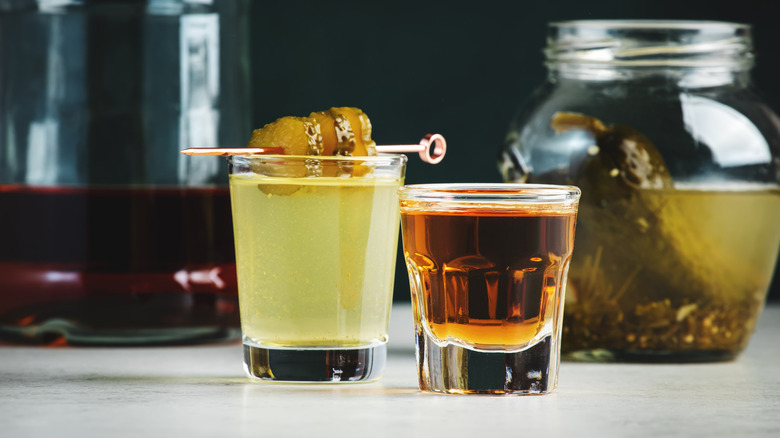 Shot glasses of whiskey and pickle brine