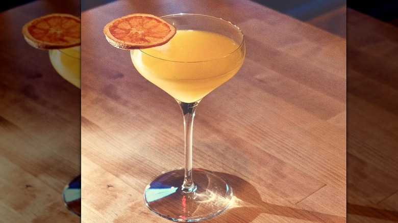 Refreshing orange cocktail in martini glass