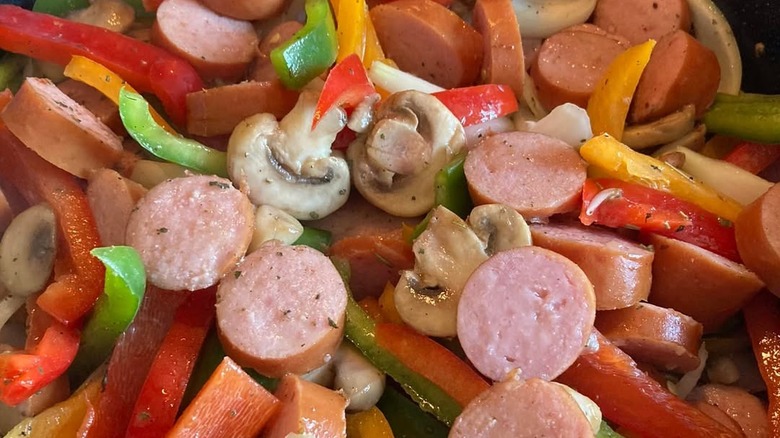 A close up of a Vienna sausage and bell pepper stir fry dish