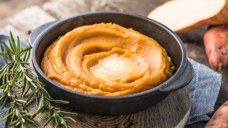 Mashed sweet potatoes in a dish with butter