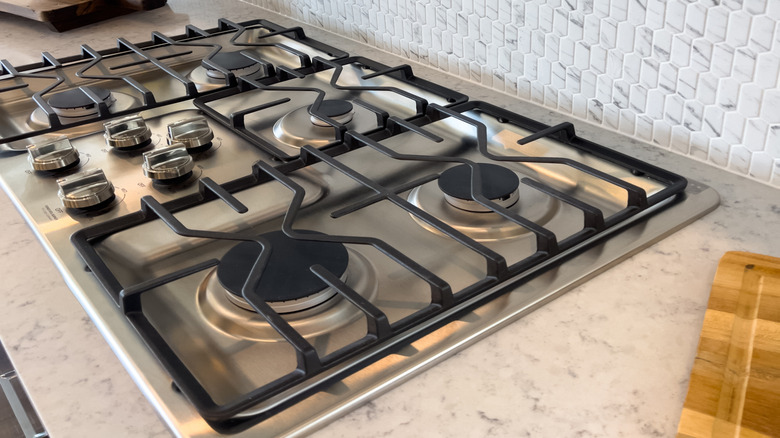 Tiled backsplash with gas stove