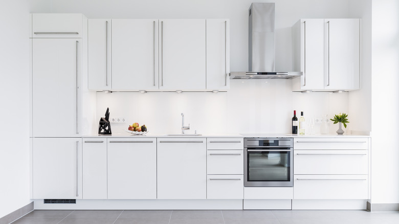 White kitchen with stainless steel stove