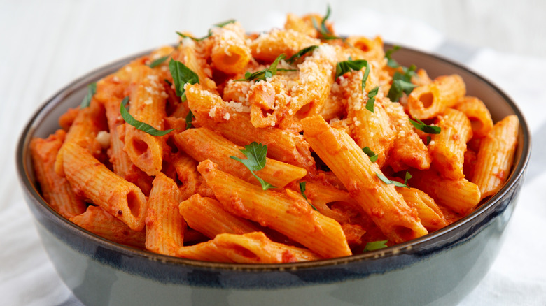 a bowl of penne alla vodka on a table