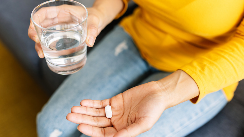 woman holding hangover remedies