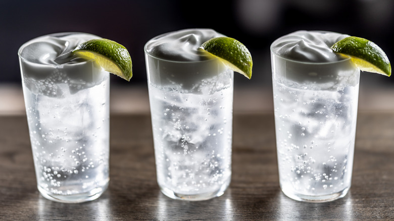 a line of vodka sodas on a bar