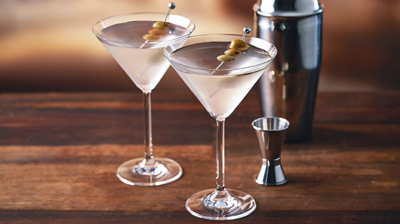 two dirty martinis on a bar