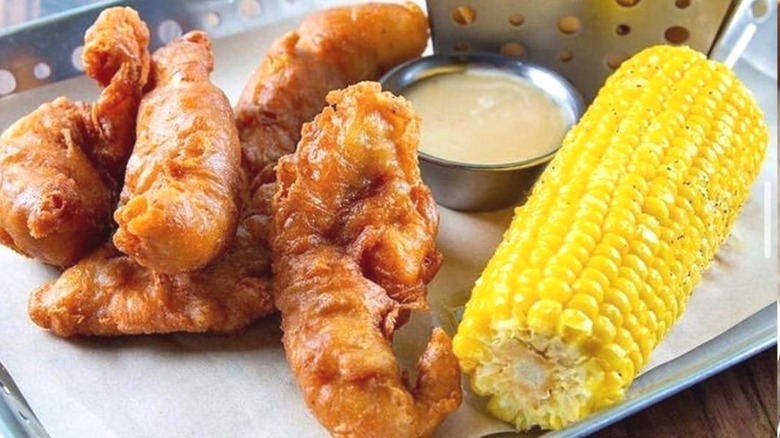 Battered chicken strips with corn cob
