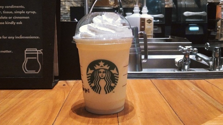 Chai crème frappuccino in a takeout cup on the counter in a Starbucks