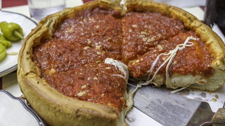 A Chicago-style deep dish pizza with a slice cut out
