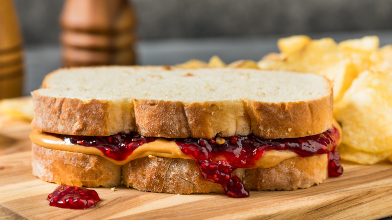 A peanut butter and jelly sandwich on a cutting board