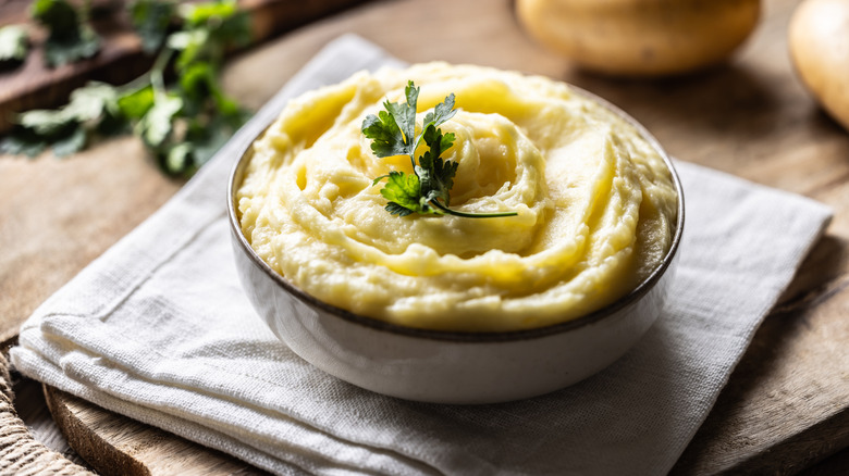 Bowl of mashed potatoes with herb topping
