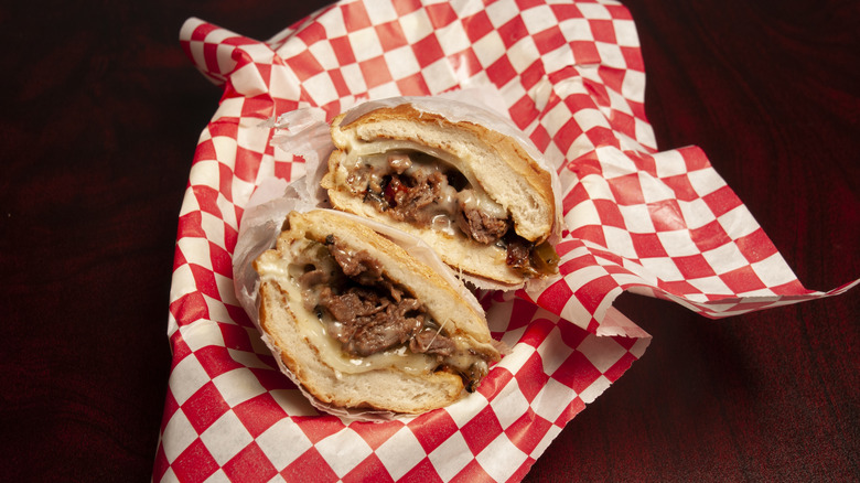 Philly cheesesteak wrapped in a checkered napkin