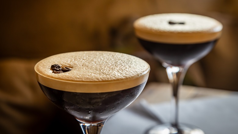 Two espresso martinis garnished with espresso beans