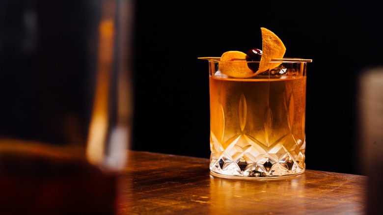 A Oaxacan old fashioned cocktail garnished an orange peel and cherry