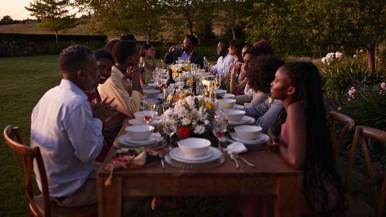 People eating at outdoor dinner party
