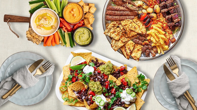 Dinner party spread with veggies, platters, and nachos