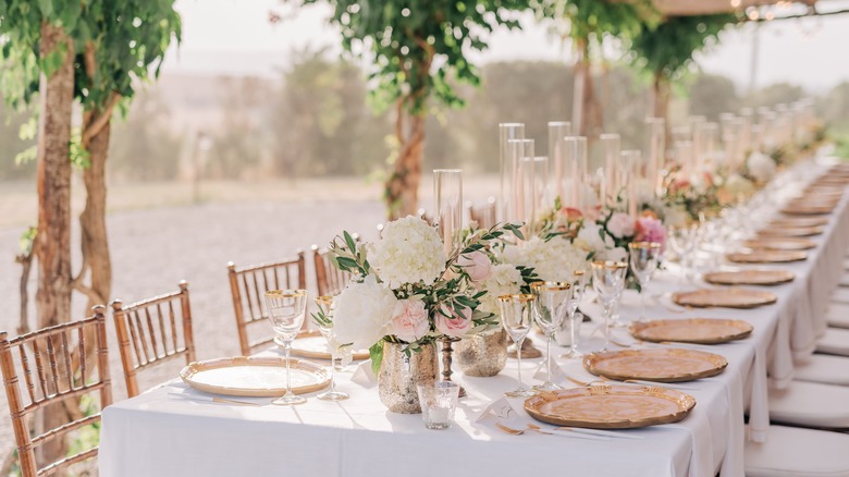 Outdoor dinner party with flowers and greenery