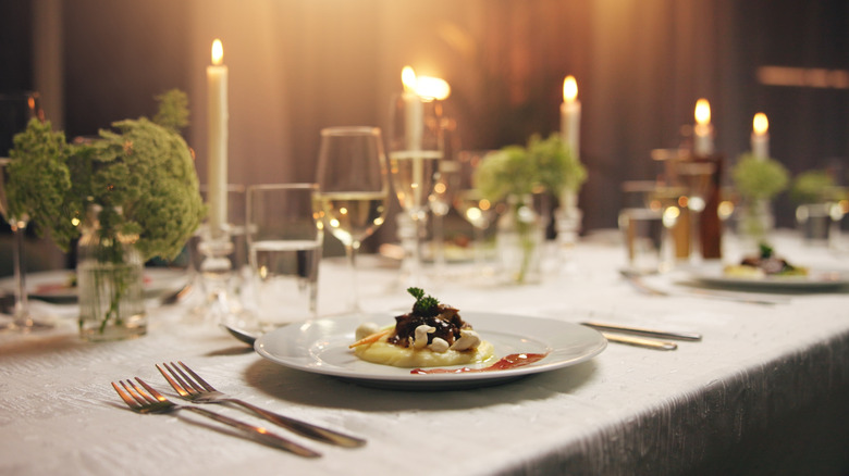 Dinner party table with plate of food
