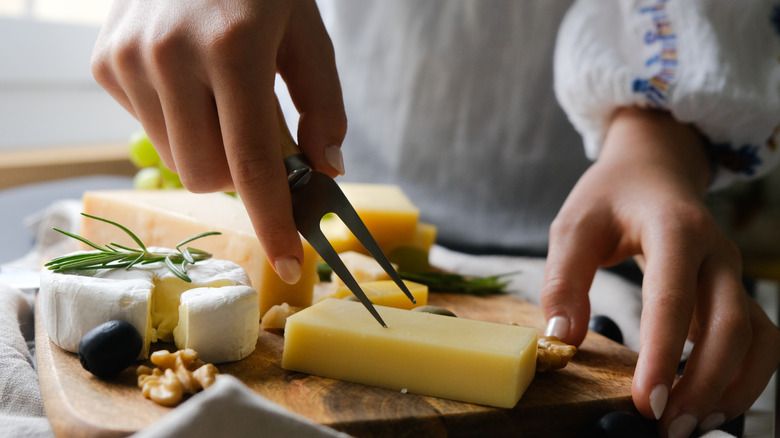 Cheese on a plate with hands