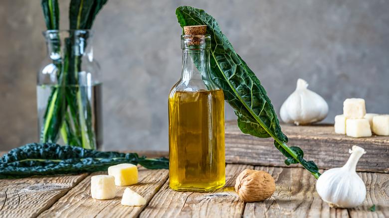 Olive oil with cheese and garlic with kale leaves