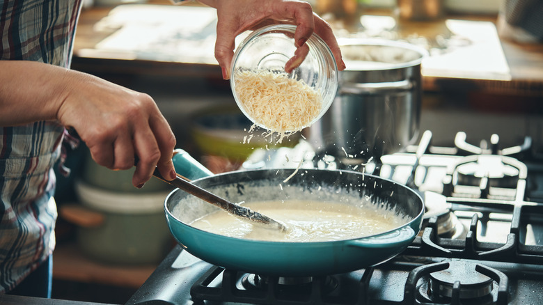 Adding Parmesan cheese to pasta sauce