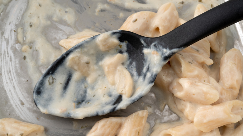 Alfredo in a pan with a spoon