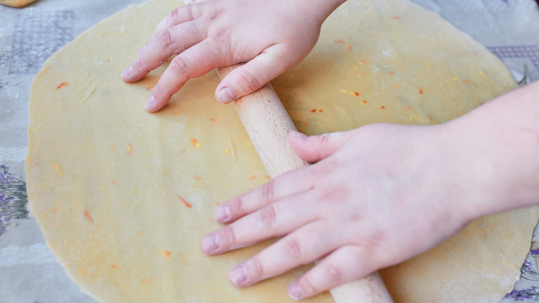 Person using a rolling pin for pie crust