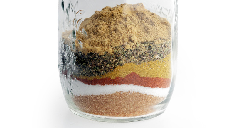 layers of spices and salt in a jar