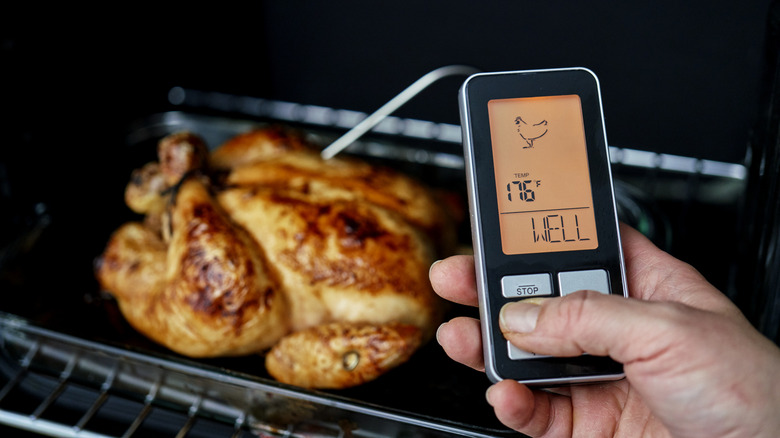 hand holding digital thermometer screen