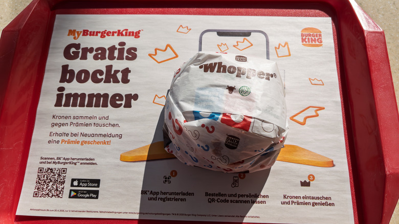 Whopper on fast food tray with German Burger King ad