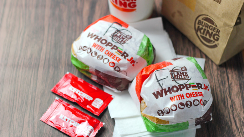 two Whopper Jr. burgers on wooden surface