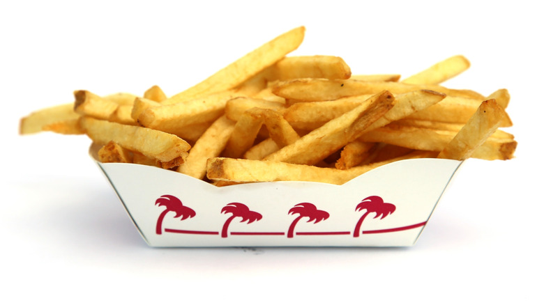 In-N-Out french fries in paper basket on white background