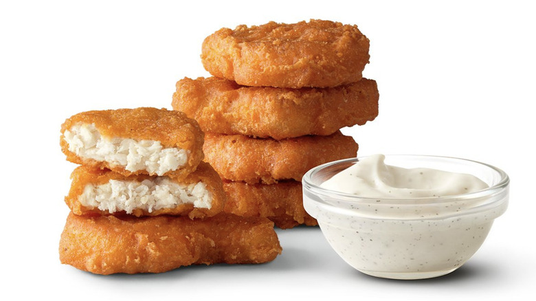 Spicy Chicken McNuggets sit next to Creamy Ranch Sauce.