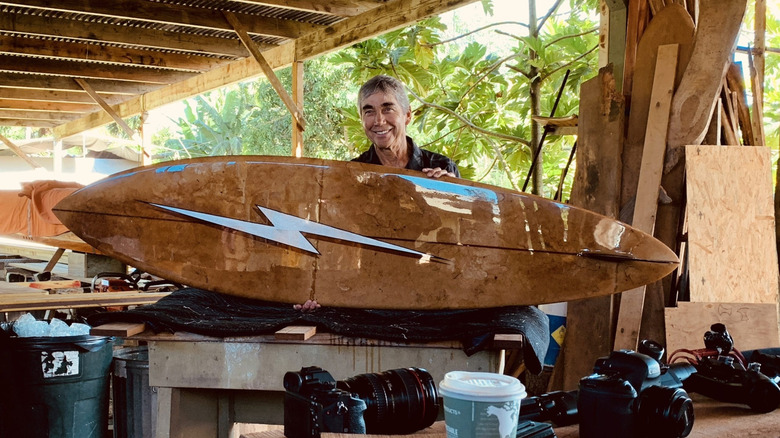 A person holding an agave surfboard