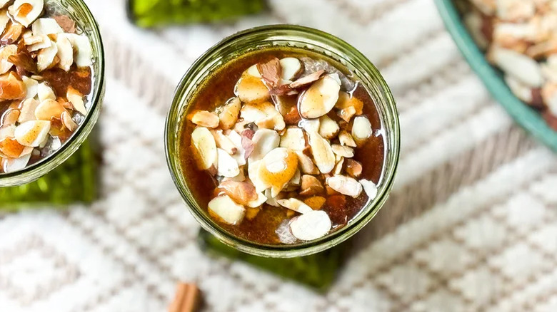 Glass serving bowl of almond chai chia pudding garnished with almonds