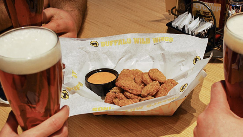 basket of fried pickles with sauce