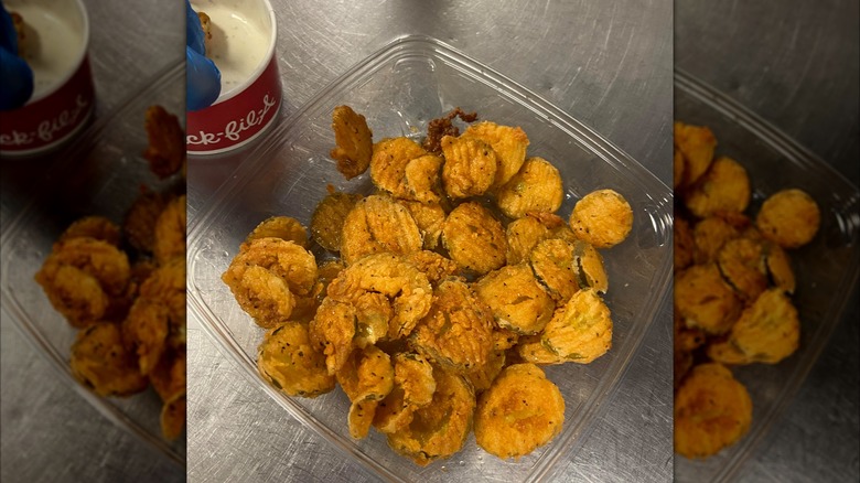 clear container filled with fried pickles