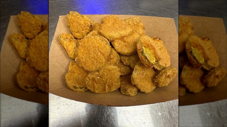 brown paper basket of fried pickles